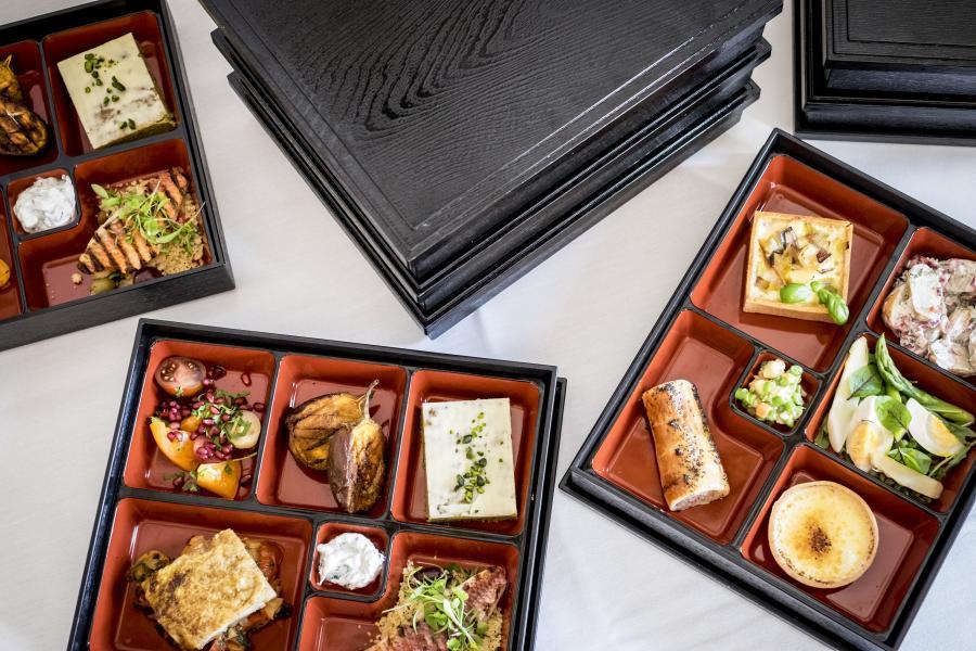 flat lay photo of bento boxes with sandwich lunch